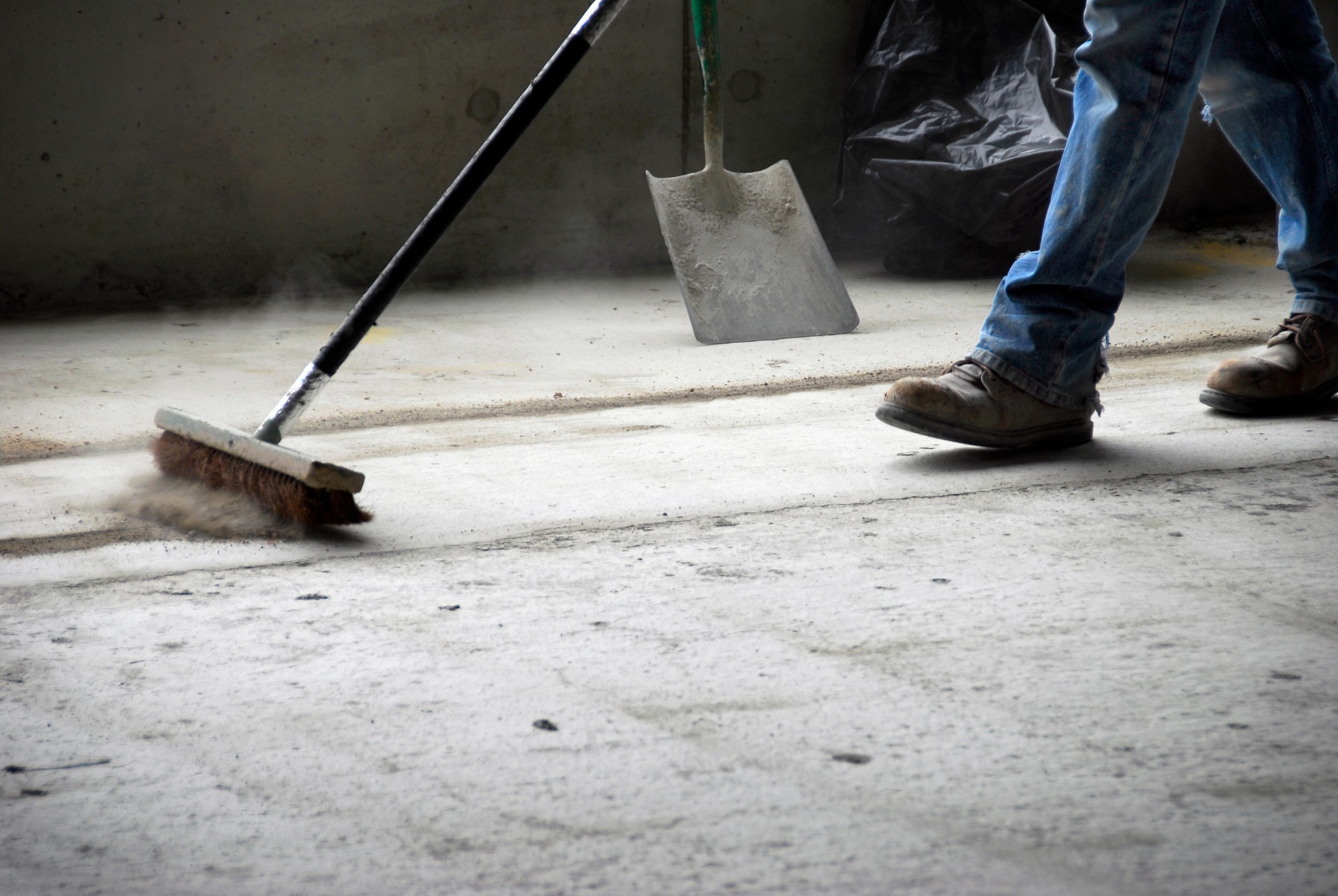 Worker Sweeping Up at Construction Site